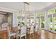 Spacious dining room with hardwood floors, modern chandelier and lots of natural light at 3347 Alamance Dr, Raleigh, NC 27609