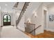 Grand foyer with a staircase, hardwood floors, and an elegant entryway creates a welcoming ambiance at 3347 Alamance Dr, Raleigh, NC 27609
