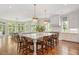 Spacious kitchen featuring a large island with seating, pendant lights, and hardwood floors at 3347 Alamance Dr, Raleigh, NC 27609