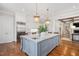 Gourmet kitchen with large island, stainless steel appliances, and hardwood floors at 3347 Alamance Dr, Raleigh, NC 27609