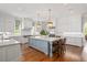 Open kitchen with an island, custom cabinets, and modern stainless steel appliances at 3347 Alamance Dr, Raleigh, NC 27609