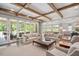 Open-concept living room boasts beamed ceilings and views into the kitchen and backyard at 3347 Alamance Dr, Raleigh, NC 27609