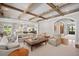 Comfortable and spacious living room with beamed ceilings and access to other rooms at 3347 Alamance Dr, Raleigh, NC 27609