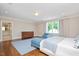 Large main bedroom featuring hardwood floors, natural light, and an ensuite bathroom view at 3347 Alamance Dr, Raleigh, NC 27609