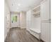 Well-organized mudroom with storage, a bench and wood-look tile flooring at 3347 Alamance Dr, Raleigh, NC 27609
