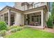 Covered outdoor space with dining, seating, stone fireplace, and outdoor kitchen perfect for entertaining at 3347 Alamance Dr, Raleigh, NC 27609