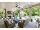 Inviting outdoor living area with a stone fireplace, overlooking the pool and gardens at 3347 Alamance Dr, Raleigh, NC 27609