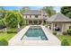 An in-ground pool is surrounded by stone pavers and ample space for lounging in the backyard of this estate home at 3347 Alamance Dr, Raleigh, NC 27609