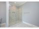Modern bathroom showcasing a glass-enclosed shower with marble tile and updated fixtures at 3347 Alamance Dr, Raleigh, NC 27609