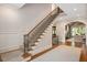 Elegant staircase with wood and iron railing, leading to the upper level of the home at 3347 Alamance Dr, Raleigh, NC 27609
