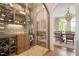 Impressive wine cellar with glass door, custom shelving and beautiful lighting at 3347 Alamance Dr, Raleigh, NC 27609