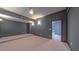 Finished basement with neutral carpeting, recessed lighting, dimmable sconces, and access to other rooms at 3408 Mount Pisgah Way, Cary, NC 27519