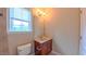 Bathroom with a wood vanity, bright lighting, and a window at 3408 Mount Pisgah Way, Cary, NC 27519