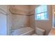 Bathroom with a tiled tub, shower, and a window at 3408 Mount Pisgah Way, Cary, NC 27519