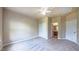 Bright bedroom featuring plush carpet, a ceiling fan, and ensuite bathroom access at 3408 Mount Pisgah Way, Cary, NC 27519