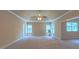 Spacious bedroom with tray ceiling, ceiling fan, and multiple windows for natural light at 3408 Mount Pisgah Way, Cary, NC 27519