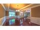 Bright and airy dining room with hardwood floors, decorative molding, and a chandelier for elegant meals at 3408 Mount Pisgah Way, Cary, NC 27519