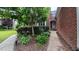 Close up of the front walkway with decorative bushes and plants leading to the front door of a brick house at 3408 Mount Pisgah Way, Cary, NC 27519