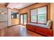 Open living room with hardwood floors and built-in seating at 3408 Mount Pisgah Way, Cary, NC 27519