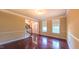 Inviting living room with hardwood floors, crown molding, and ample natural light, adjacent to the staircase at 3408 Mount Pisgah Way, Cary, NC 27519