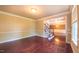 Spacious living room featuring hardwood floors, crown molding, and a staircase leading to the upper level at 3408 Mount Pisgah Way, Cary, NC 27519