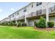 View of the row of townhomes and their backyard landscaping at 364 Skymont Dr, Holly Springs, NC 27540