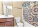 Bathroom with a shower tub, vanity, mirror, and colorful shower curtain at 364 Skymont Dr, Holly Springs, NC 27540