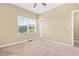 Neutral bedroom featuring a window offering natural light and closet door at 364 Skymont Dr, Holly Springs, NC 27540