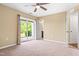 Bedroom featuring carpeted floors, a ceiling fan, a sliding glass door, and neutral-colored walls at 364 Skymont Dr, Holly Springs, NC 27540