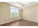 Bright dining room features modern chandelier lighting, natural light from a window, and wood flooring at 364 Skymont Dr, Holly Springs, NC 27540