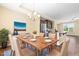 Staged dining area showcasing a modern table set, a chandelier, and a glimpse into the kitchen at 364 Skymont Dr, Holly Springs, NC 27540