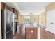 Kitchen with stainless steel appliances, dark wood cabinets, granite countertops, and an island at 364 Skymont Dr, Holly Springs, NC 27540