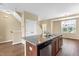 Features an island with a stainless dishwasher, dark wood cabinets, and granite countertops at 364 Skymont Dr, Holly Springs, NC 27540