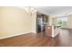 Open kitchen with stainless steel appliances, island with granite countertops, and wood flooring at 364 Skymont Dr, Holly Springs, NC 27540