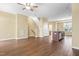 Open living space with hardwood floors, stairway, and kitchen island with stainless steel dishwasher at 364 Skymont Dr, Holly Springs, NC 27540