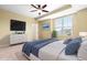 Bedroom boasts a ceiling fan, window with natural light, and modern dresser at 364 Skymont Dr, Holly Springs, NC 27540