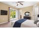 Bedroom with carpeted floors, sliding glass door, bench, dresser and a bed with blue accents at 364 Skymont Dr, Holly Springs, NC 27540