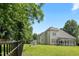 Well-manicured backyard featuring a black fence, garden, and a covered porch for outdoor living at 37 Meadow Oaks Cir, Smithfield, NC 27577