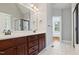 Bathroom vanity with double sinks, dark cabinets, and a doorway to a walk in shower at 37 Meadow Oaks Cir, Smithfield, NC 27577