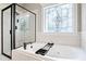 Bathroom features a garden tub with decorative window and glass enclosed shower at 37 Meadow Oaks Cir, Smithfield, NC 27577