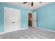 Bedroom showcasing neutral carpet, a ceiling fan, and a double door closet leading to upstairs hallway at 37 Meadow Oaks Cir, Smithfield, NC 27577