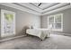 Bedroom with neutral colored carpet, two windows and a ceiling fan at 37 Meadow Oaks Cir, Smithfield, NC 27577