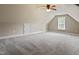 Upstairs bonus room showcasing neutral carpet, a ceiling fan, and a window providing natural light at 37 Meadow Oaks Cir, Smithfield, NC 27577