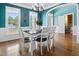 Bright dining room featuring hardwood floors, large windows, and an elegant chandelier at 37 Meadow Oaks Cir, Smithfield, NC 27577