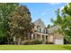 Beautiful home exterior with lush landscaping, mature trees, and a well-maintained lawn at 37 Meadow Oaks Cir, Smithfield, NC 27577