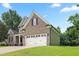 Exterior of a home with a brick facade and a white two-car garage door and well manicured lawn at 37 Meadow Oaks Cir, Smithfield, NC 27577