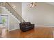 Bright living room with hardwood floors, a staircase, and natural light with a large vaulted ceiling at 37 Meadow Oaks Cir, Smithfield, NC 27577