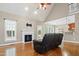 Spacious living room with a fireplace, hardwood floors, vaulted ceiling, and natural light at 37 Meadow Oaks Cir, Smithfield, NC 27577
