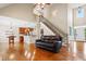 Open-concept living room with hardwood floors, a staircase, and a view into the kitchen at 37 Meadow Oaks Cir, Smithfield, NC 27577