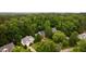 Aerial view of a home nestled among mature trees in a tranquil neighborhood at 3908 Sterling Ridge Ln, Durham, NC 27707